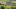 Das Bild zeigt ein Dorf mit alten Häusern und Neubauten